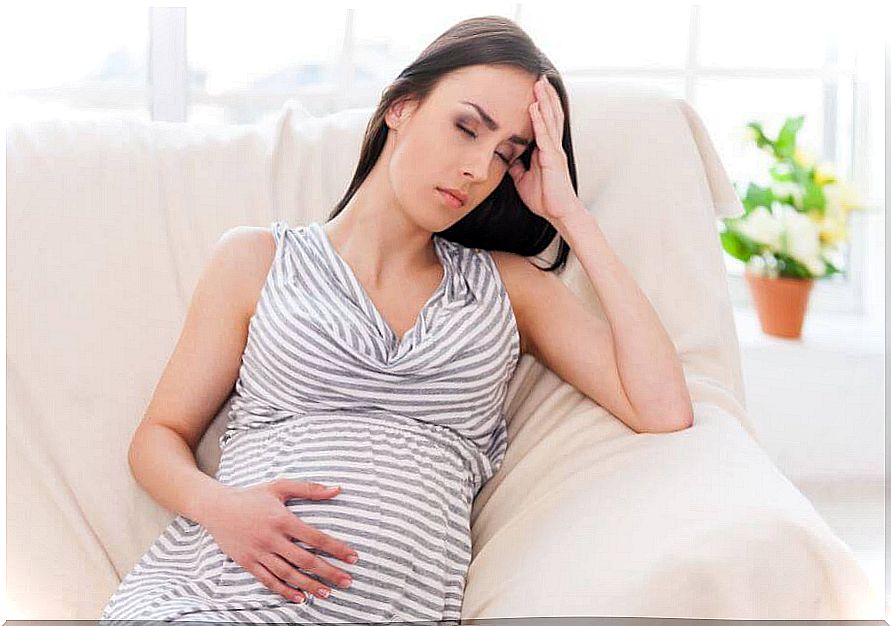 Pregnant woman on the couch.