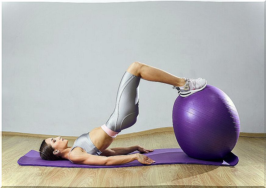 Girl doing pilates with a swiss ball