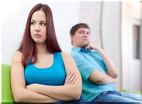 Girl turning her back to guy on the couch.