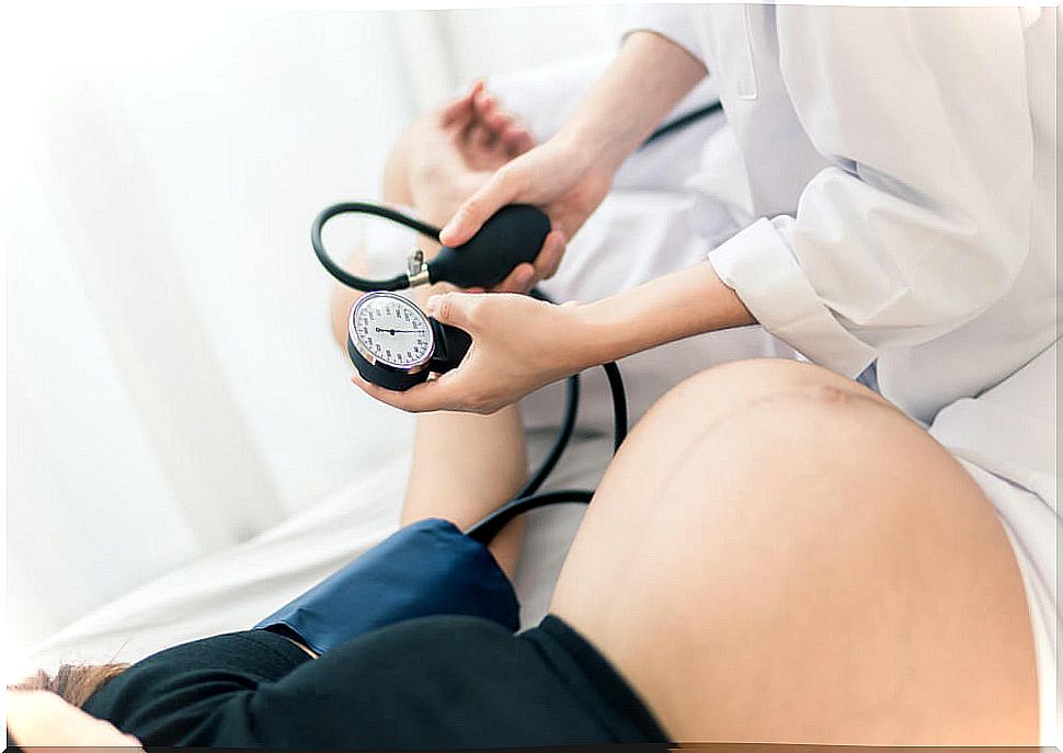 pregnant woman measuring blood pressure