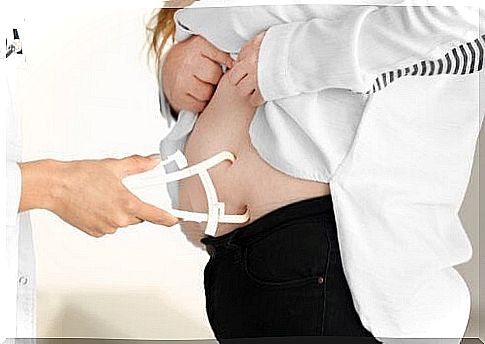 Doctor measuring abdominal fat