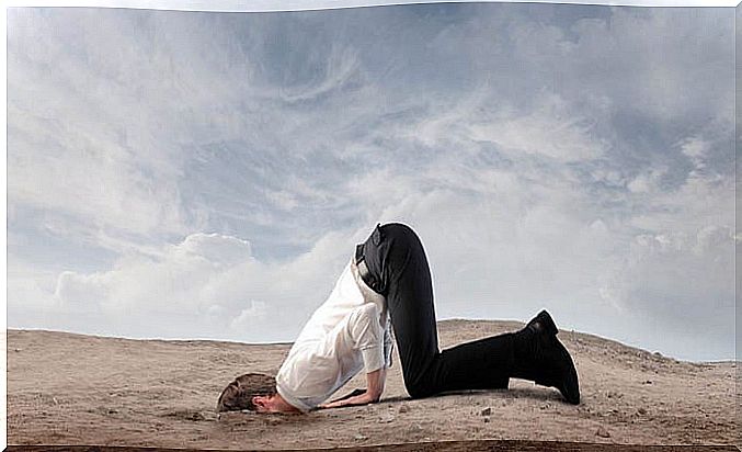 man with his head on the ground hiding his emotions