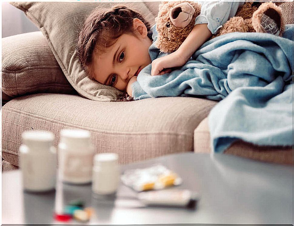 Boy on sofa looking at medicines