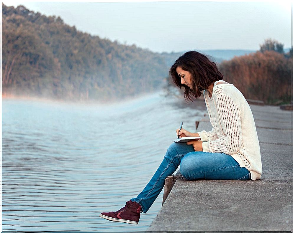 Woman writing in her emotional diary