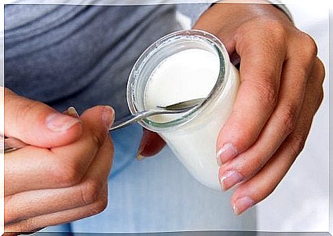 Woman eating a yogurt